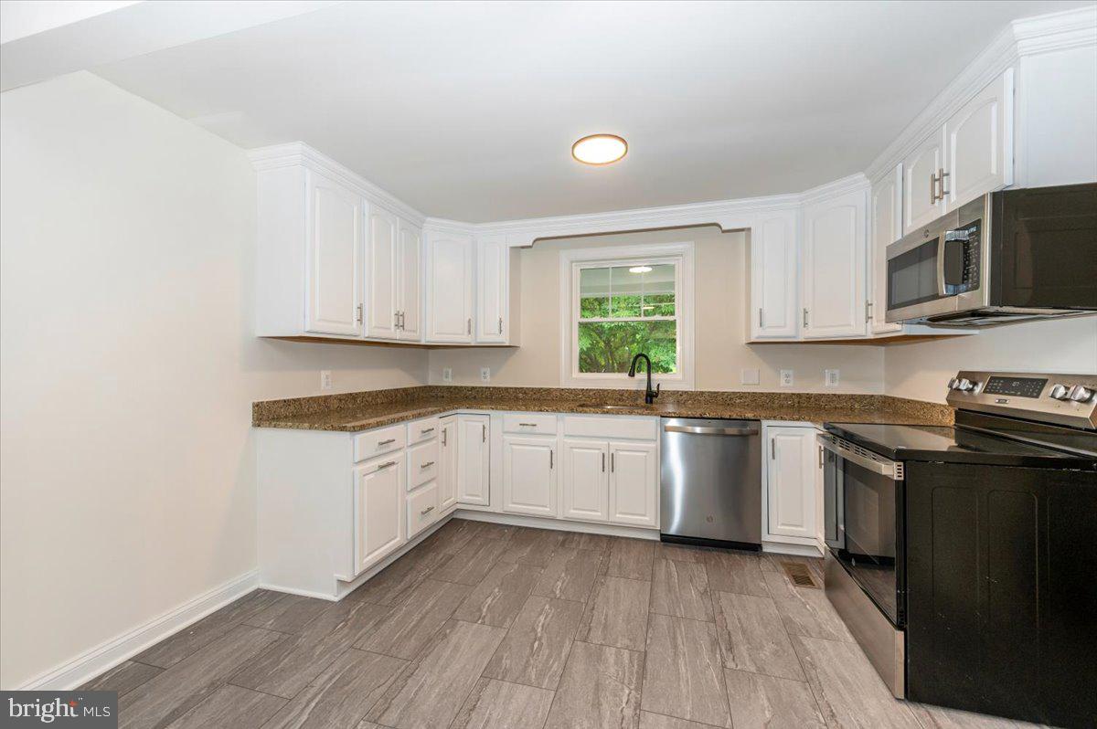 1802 Ridge Road Westminster, MD 21157 - Photo 14 of 47 a kitchen with stainless steel appliances granite countertop a stove a sink and a microwave