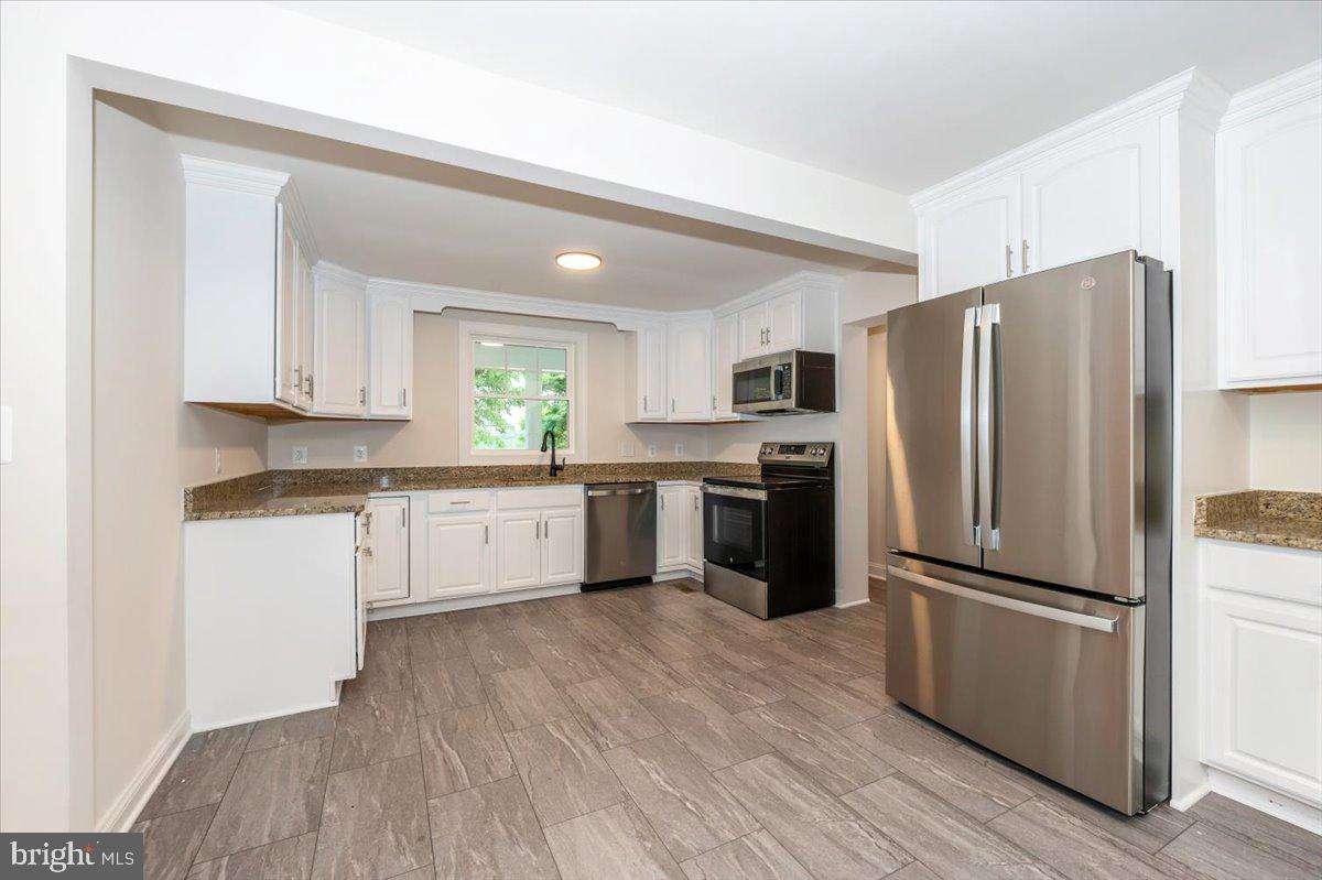 1802 Ridge Road Westminster, MD 21157 - Photo 16 of 47 a kitchen with a refrigerator cabinets and wooden floor