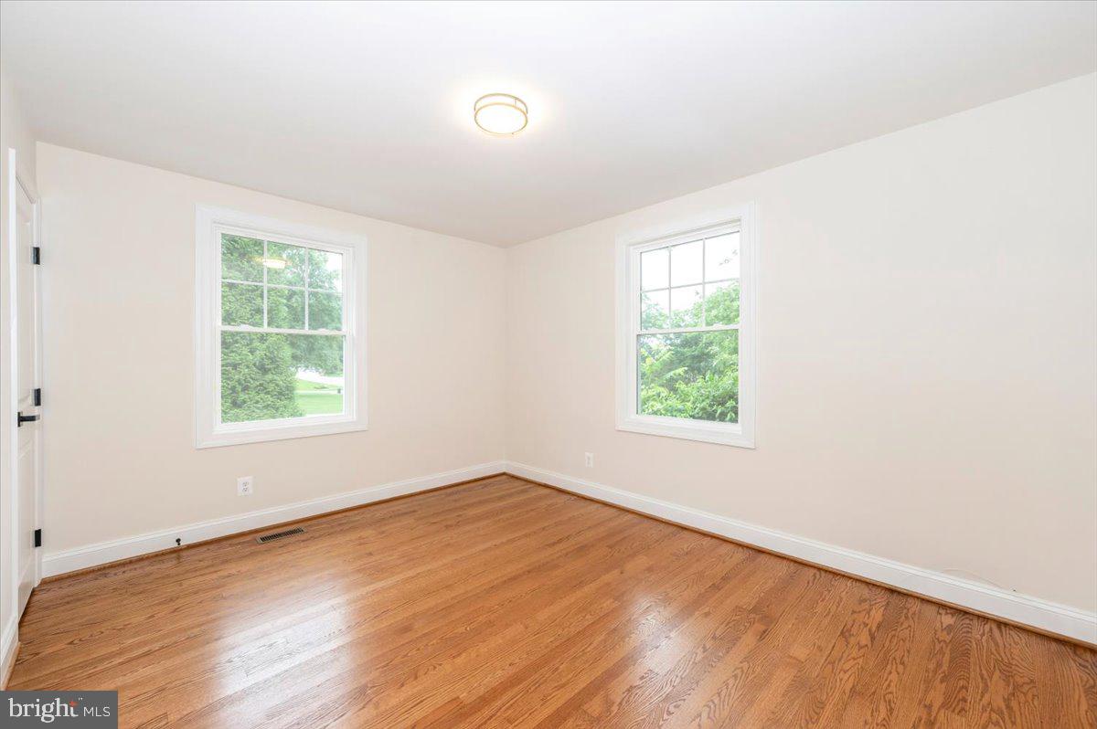 1802 Ridge Road Westminster, MD 21157 - Photo 18 of 47 an empty room with wooden floor and windows