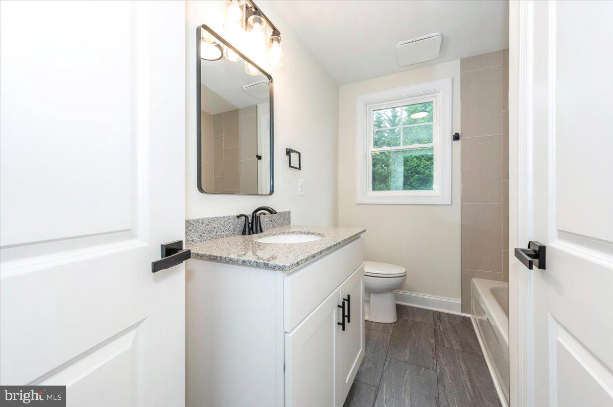 1802 Ridge Road Westminster, MD 21157 - Photo 24 of 47 a bathroom with a granite countertop sink toilet and mirror