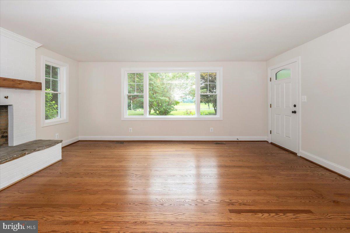 1802 Ridge Road Westminster, MD 21157 - Photo 7 of 47 an empty room with wooden floor and windows