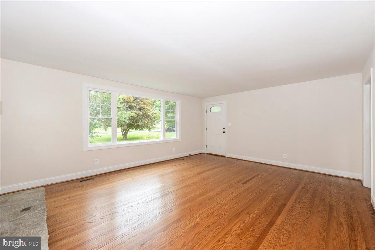 1802 Ridge Road Westminster, MD 21157 - Photo 8 of 47 an empty room with wooden floor and windows
