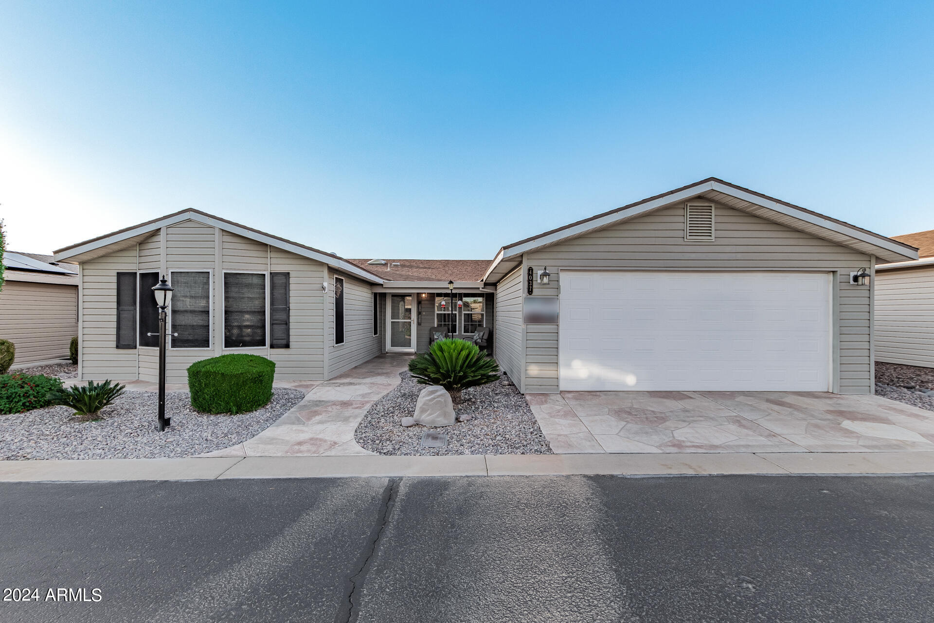 3301 South Goldfield Road, Unit 4037 Apache Junction, AZ 85119 - Photo 1 of 36 a front view of a house with garden