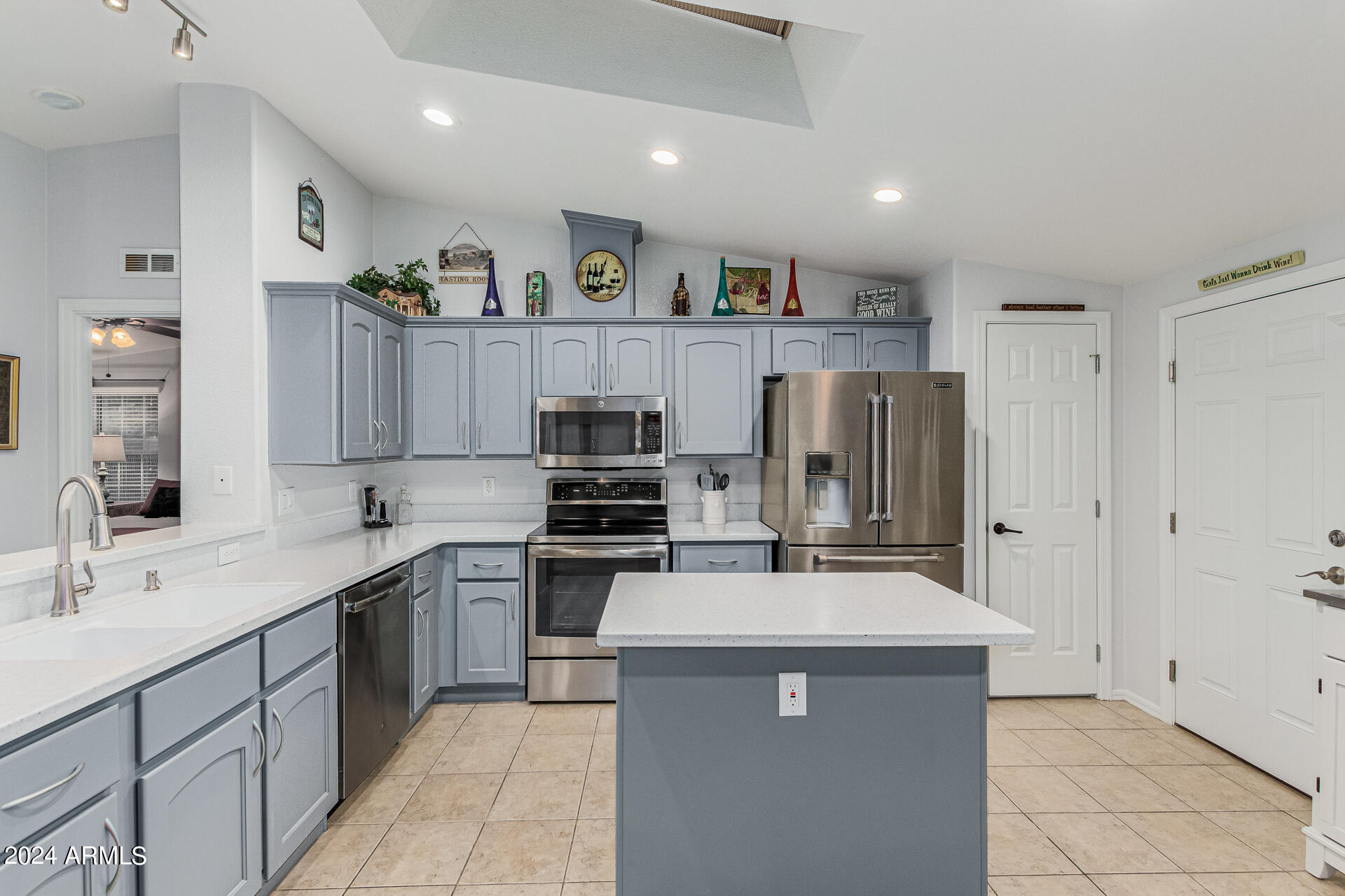 3301 South Goldfield Road, Unit 4037 Apache Junction, AZ 85119 - Photo 12 of 36 a kitchen with refrigerator and cabinets