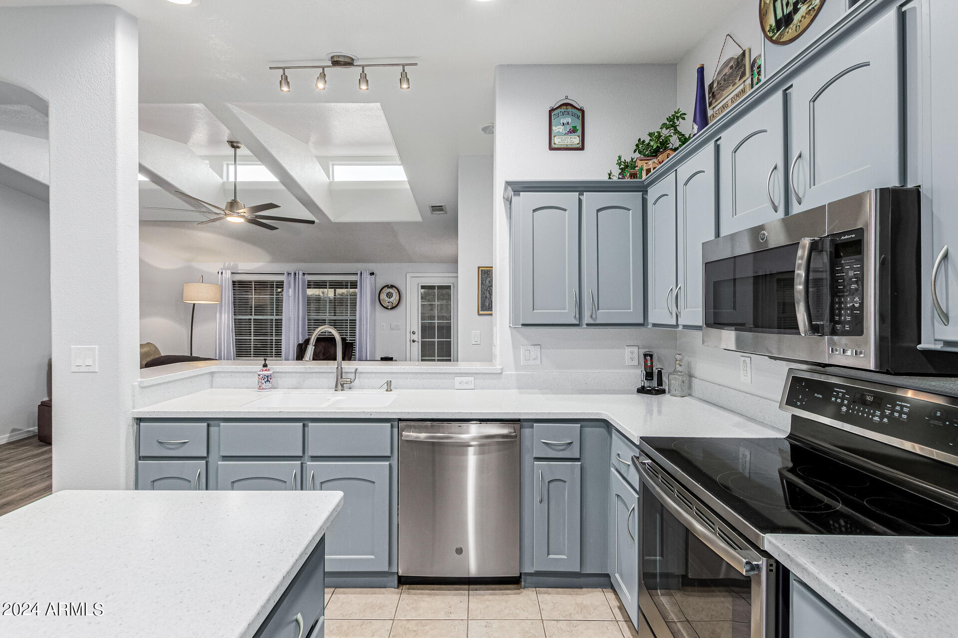 3301 South Goldfield Road, Unit 4037 Apache Junction, AZ 85119 - Photo 13 of 36 a kitchen with stainless steel appliances granite countertop a sink and a stove