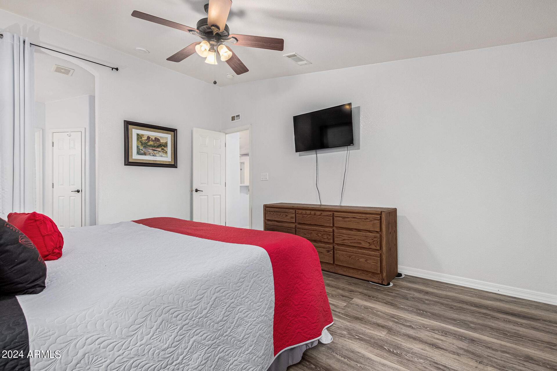 3301 South Goldfield Road, Unit 4037 Apache Junction, AZ 85119 - Photo 19 of 36 a bedroom with a bed and a flat screen tv