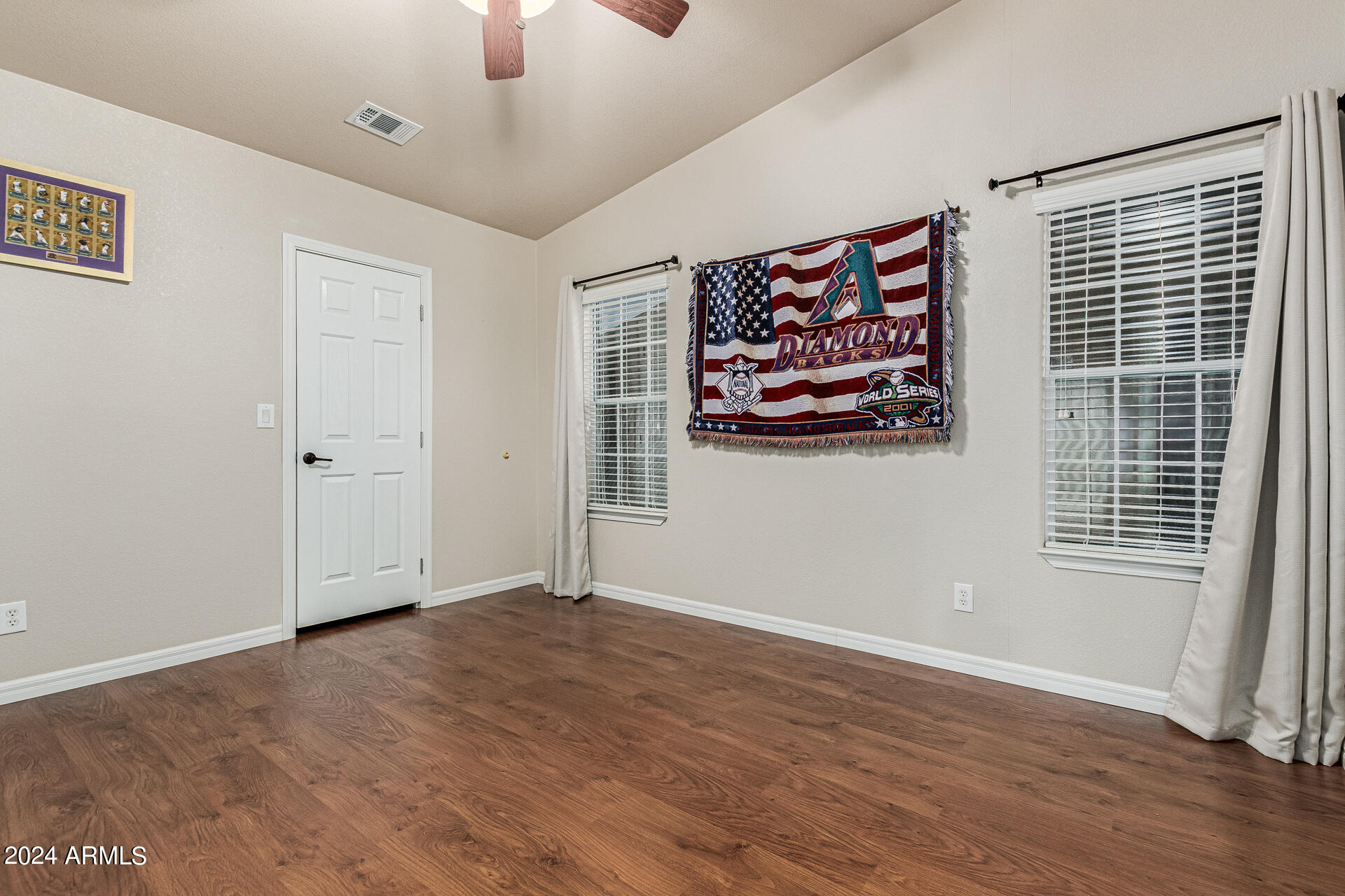 3301 South Goldfield Road, Unit 4037 Apache Junction, AZ 85119 - Photo 24 of 36 an empty room with wooden floor and windows