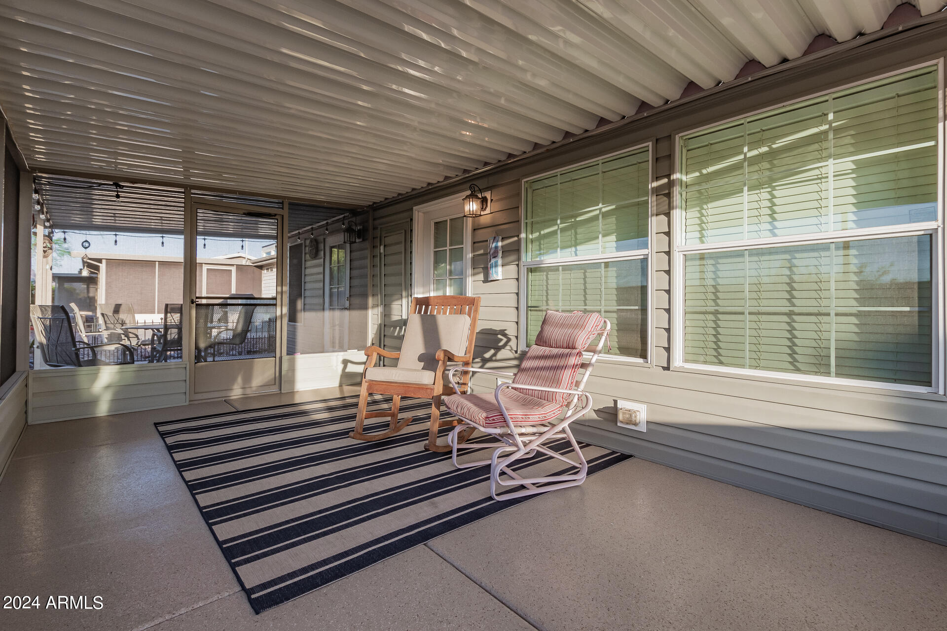 3301 South Goldfield Road, Unit 4037 Apache Junction, AZ 85119 - Photo 31 of 36 a view of a patio with table and chairs with wooden floor