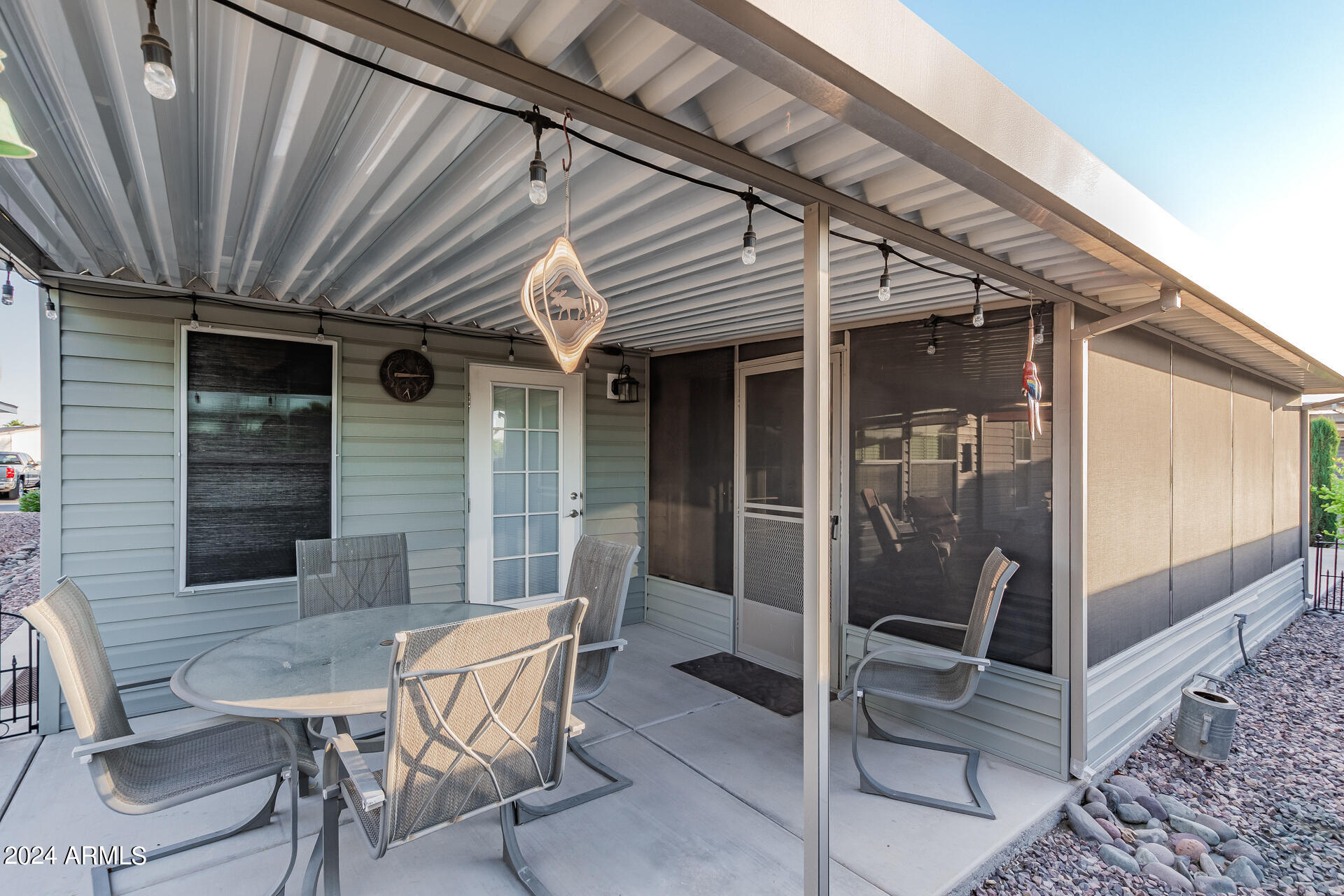 3301 South Goldfield Road, Unit 4037 Apache Junction, AZ 85119 - Photo 32 of 36 a patio with table and chairs and potted plants
