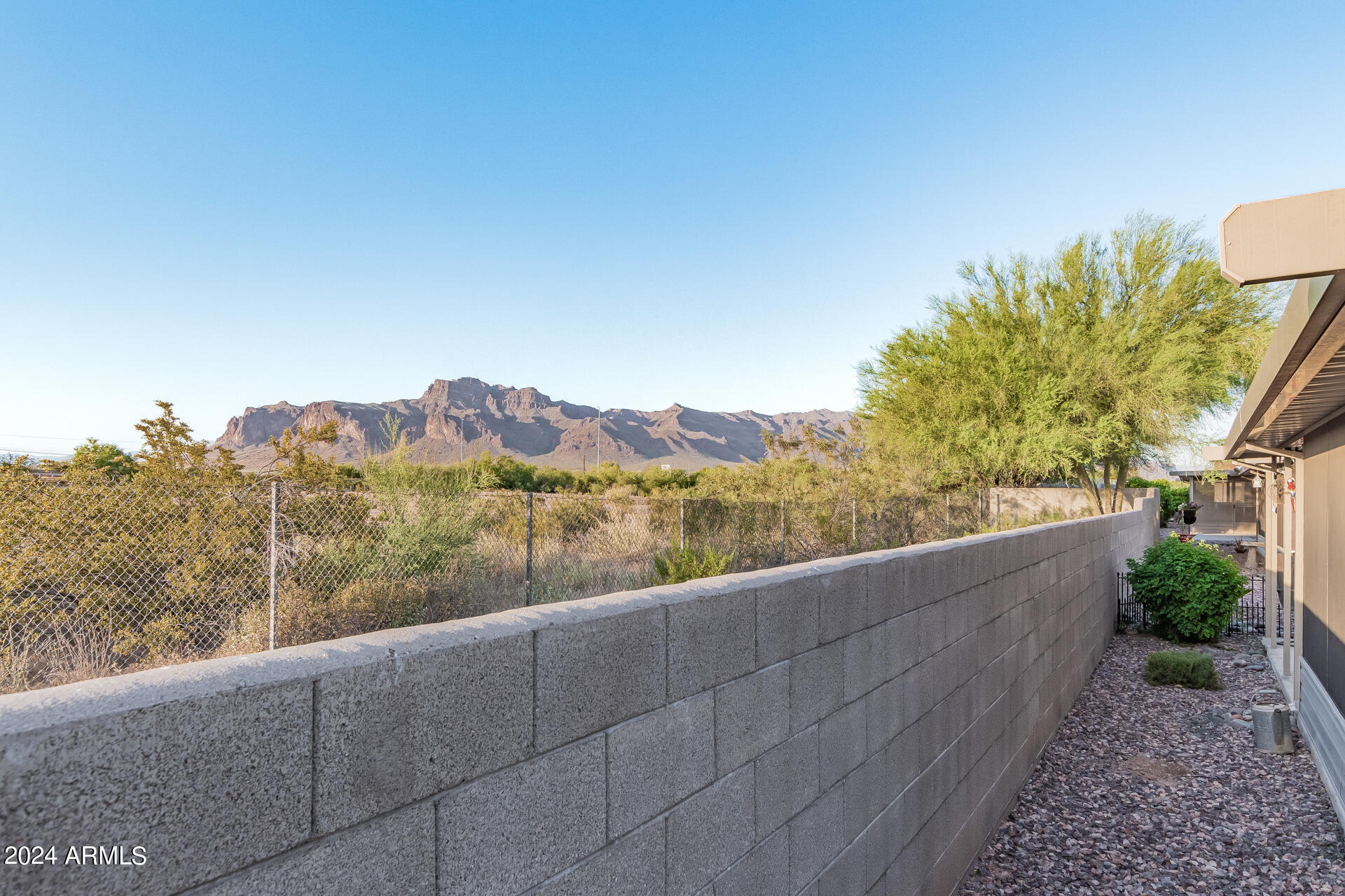 3301 South Goldfield Road, Unit 4037 Apache Junction, AZ 85119 - Photo 35 of 36 a view of a lake with a mountain in the background