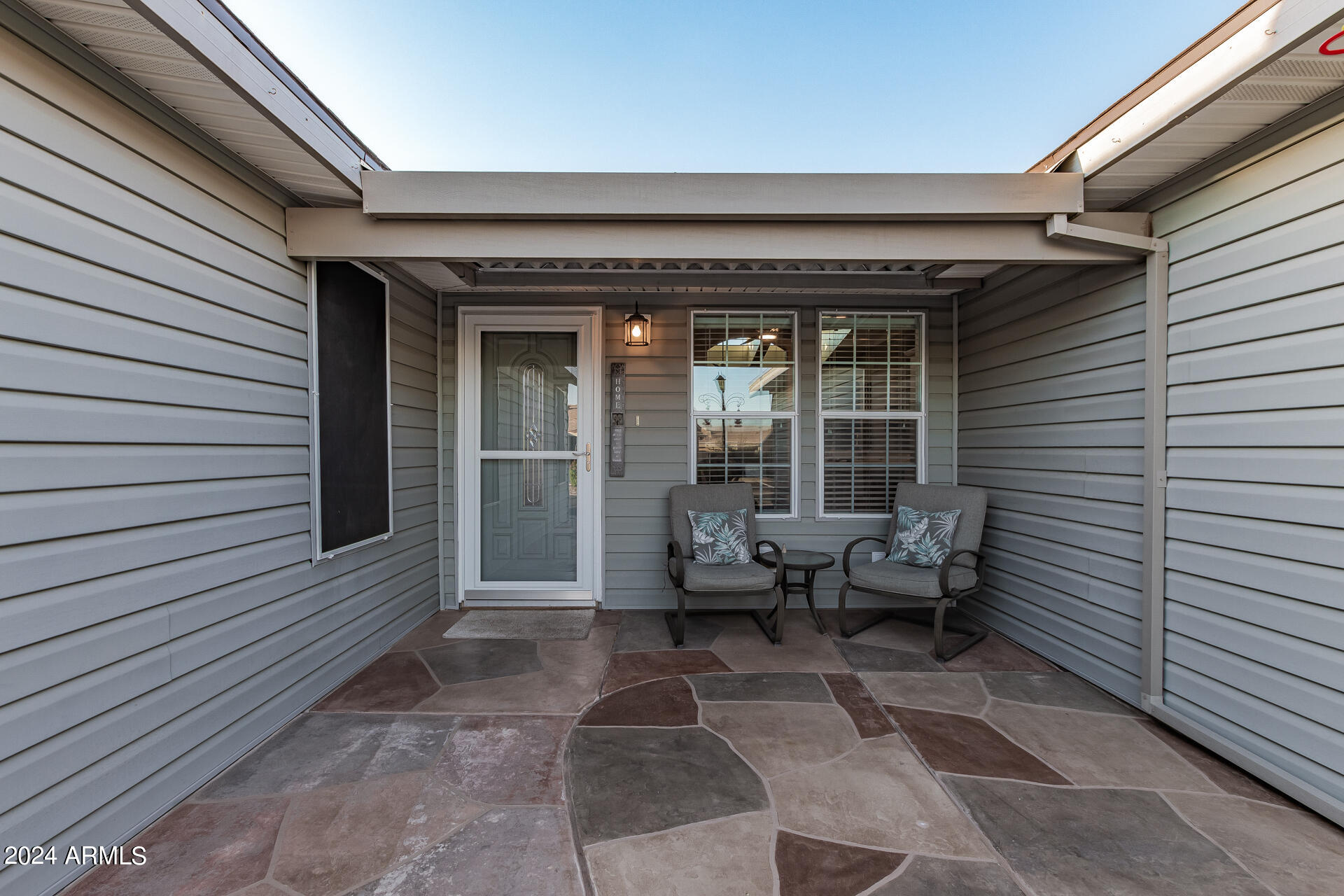 3301 South Goldfield Road, Unit 4037 Apache Junction, AZ 85119 - Photo 5 of 36 a view of a patio with table and chairs and floor to ceiling window