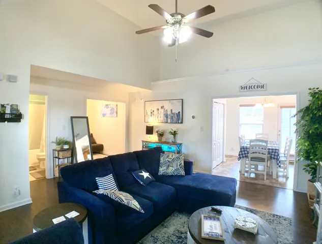 a living room with furniture and wooden floor