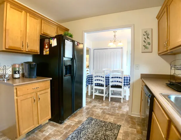 a kitchen with stainless steel appliances granite countertop a refrigerator and cabinets