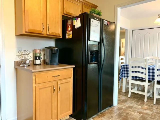 a kitchen with stainless steel appliances granite countertop a refrigerator and a stove