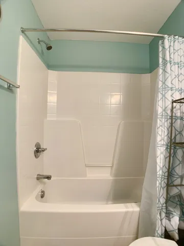 a bathroom with a shower and a bath tub