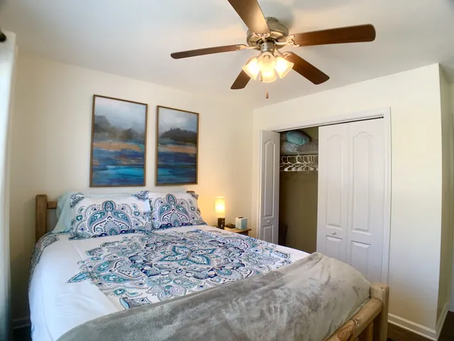 a bedroom with a large bed and a window