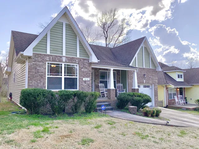 a view of a house with a yard and plants