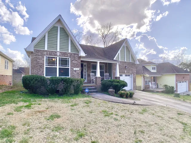 a view of a yard in front of a brick house