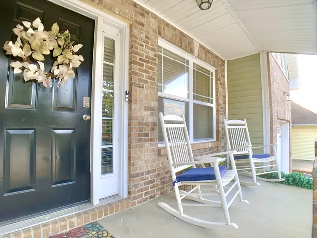 a front view of a house with outdoor seating