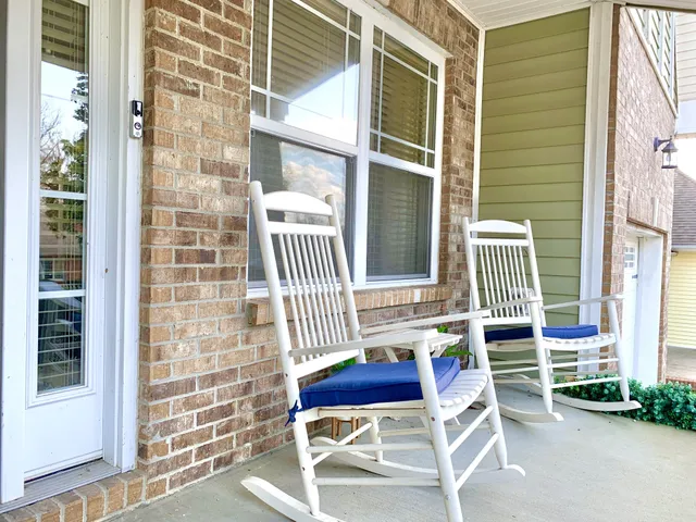 a balcony with table and chairs