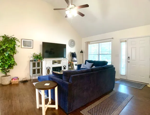 a living room with furniture and a flat screen tv