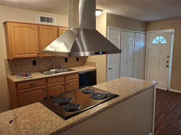 a kitchen with a stove and a sink