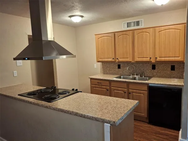 a kitchen with a sink stove and cabinets