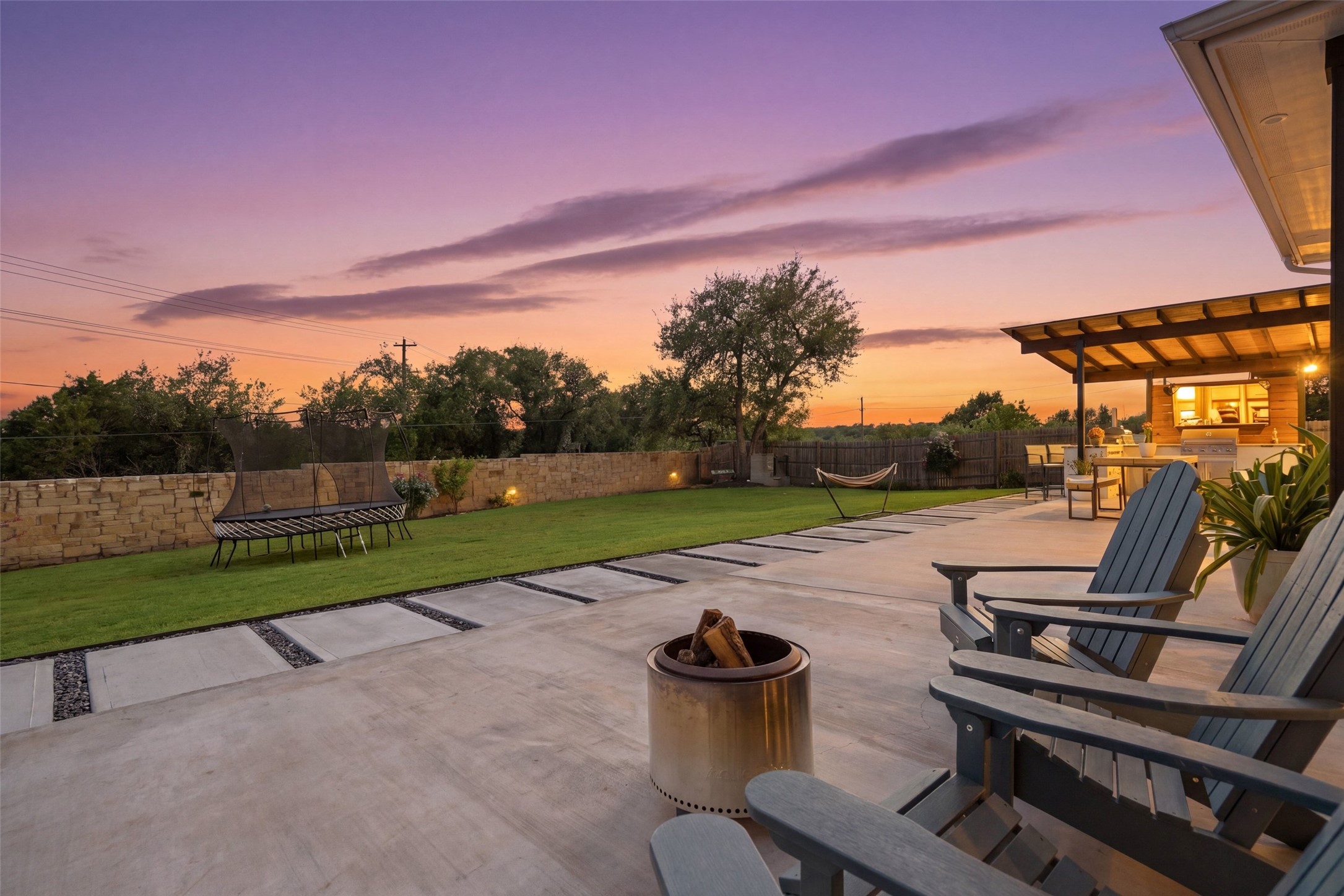 a view of a patio with chairs and a yard
