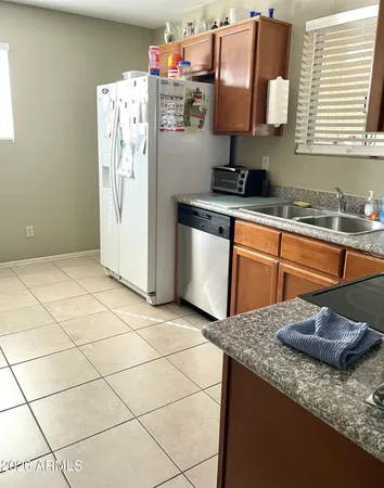 a kitchen with stainless steel appliances granite countertop a sink stove and a refrigerator