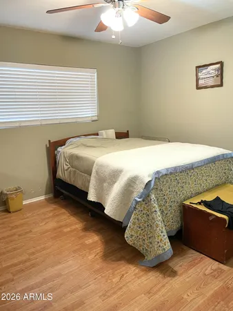 a bedroom with a bed and a desk