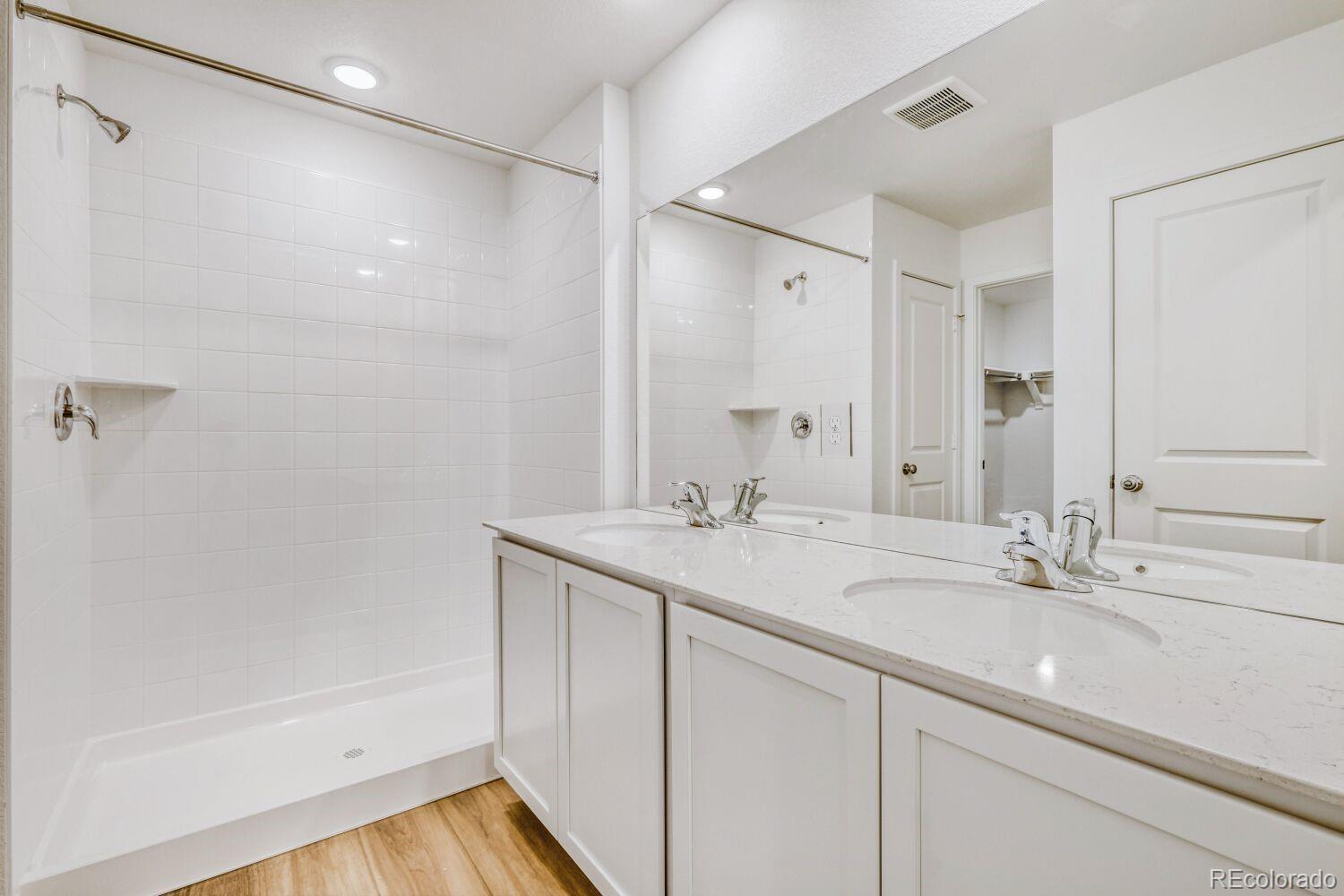 8922 Blue Feather Loop Colorado Springs, CO 80908 - Photo 12 of 18 a bathroom with a sink and a mirror