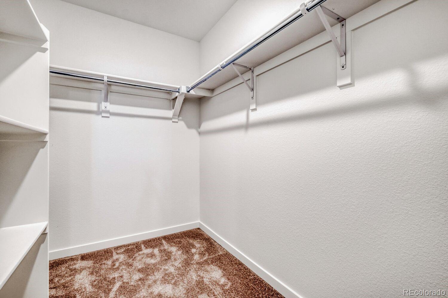 8922 Blue Feather Loop Colorado Springs, CO 80908 - Photo 13 of 18 a view of a room with racks on the wall
