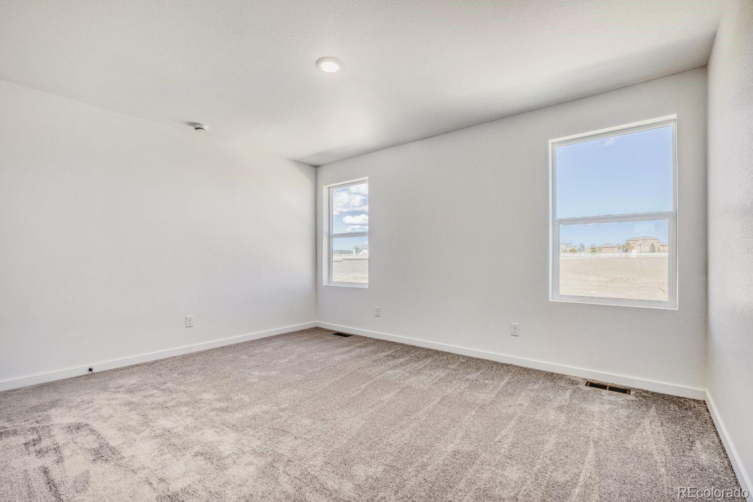 8922 Blue Feather Loop Colorado Springs, CO 80908 - Photo 14 of 18 an empty room with windows