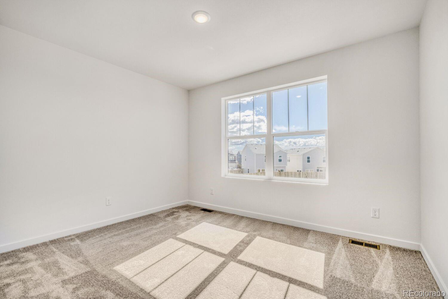 8922 Blue Feather Loop Colorado Springs, CO 80908 - Photo 16 of 18 an empty room with a window