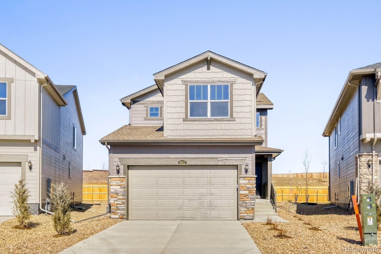 8922 Blue Feather Loop Colorado Springs, CO 80908 - Photo 6 of 18 a front view of a house with a yard