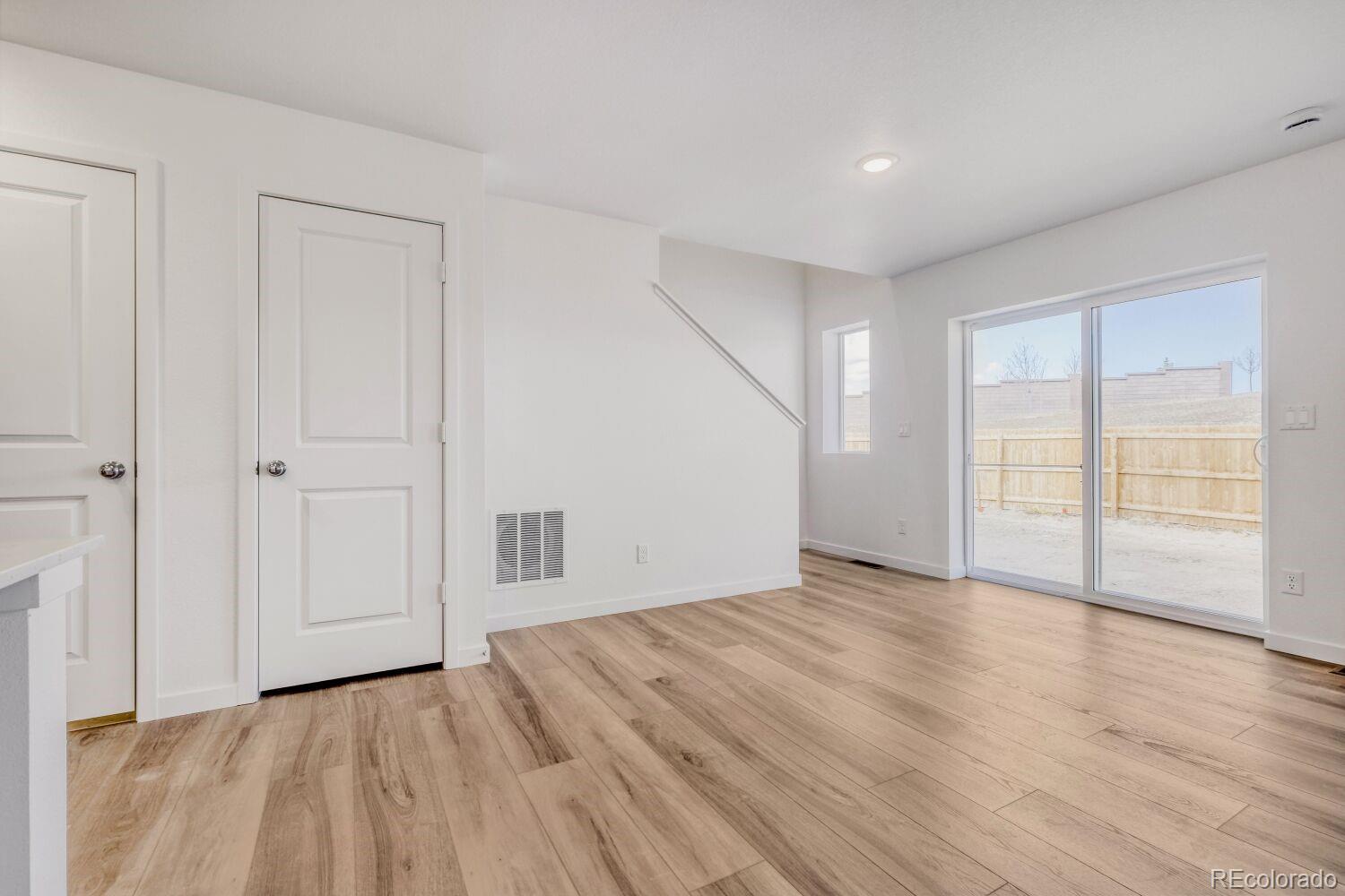 8922 Blue Feather Loop Colorado Springs, CO 80908 - Photo 9 of 18 a view of an empty room with wooden floor and a window