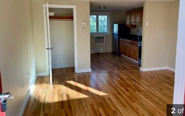 a kitchen with wooden floors and refrigerator