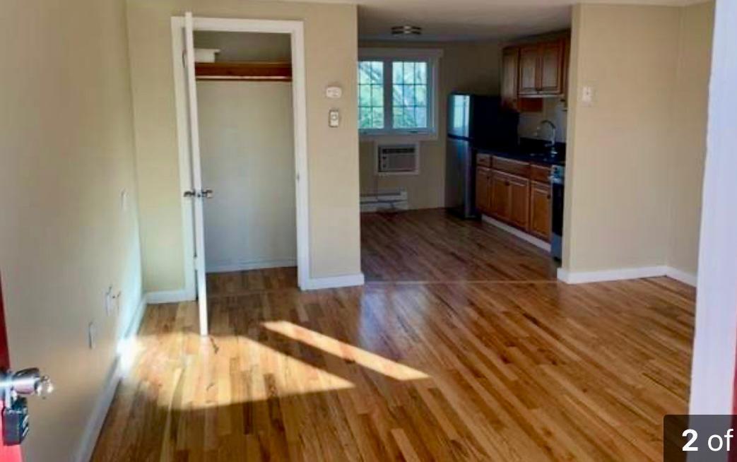 35 Parker Road, Unit 26 East Falmouth, MA 02536 - Photo 2 of 4 a kitchen with wooden floors and refrigerator