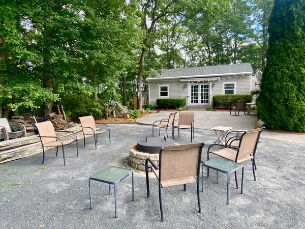 a view of a house with backyard and sitting area