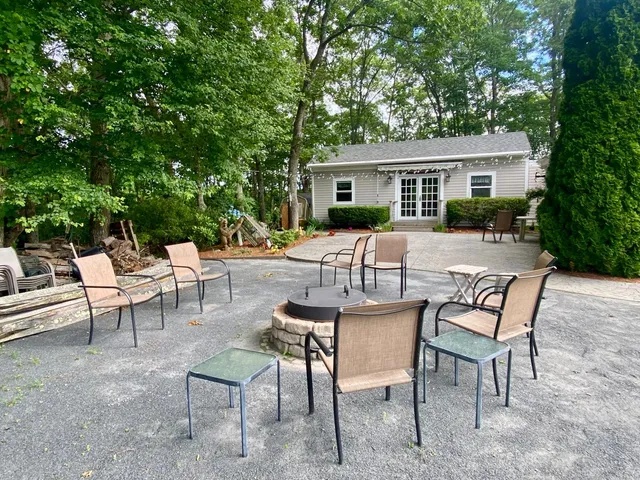 a view of a house with backyard and sitting area