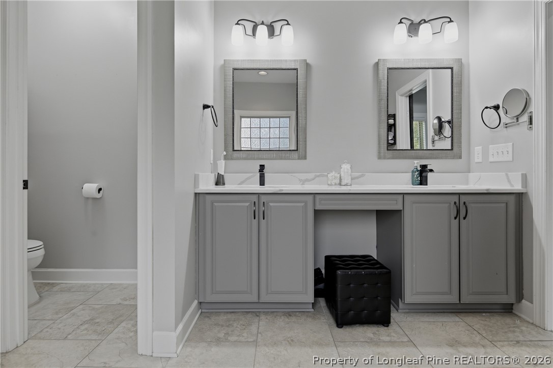 148 Heatherspring Way Spring Lake, NC 28390 - Photo 30 of 50 a bathroom with a double vanity sink and mirror