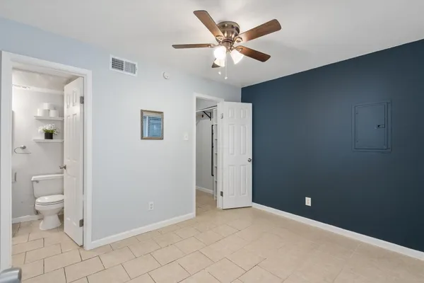 wooden floor in an empty room with a bathroom