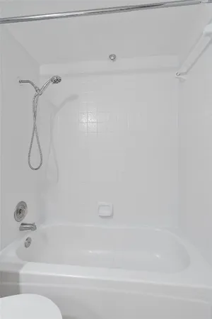 a bathroom with a shower and a bath tub