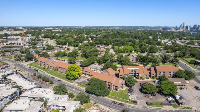 an aerial view of residential houses with city view