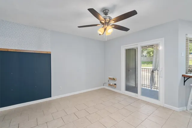 a view of a livingroom with a ceiling fan and window