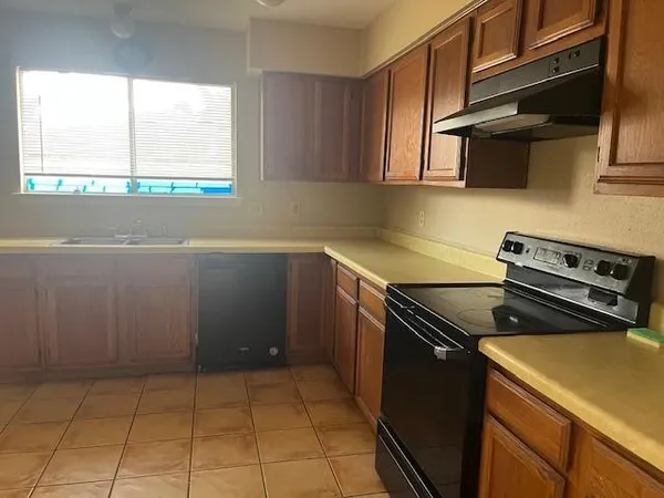 a kitchen with stainless steel appliances granite countertop a sink stove and microwave