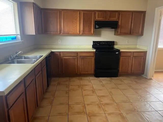 a kitchen with a cabinets and a stove top oven