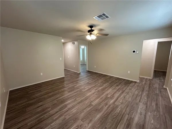 wooden floor in an empty room with a window