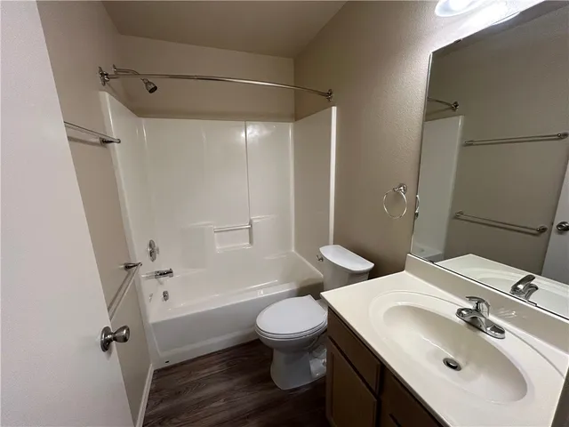 a bathroom with a sink toilet tub and shower