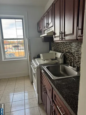 a kitchen that has a sink and a stove